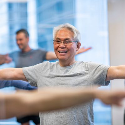 A workplace yoga participant smiling during an accessible movement session