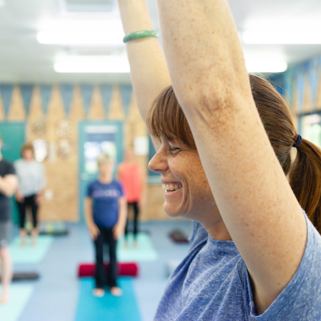 Heather Robbins smiling while guiding a yoga class