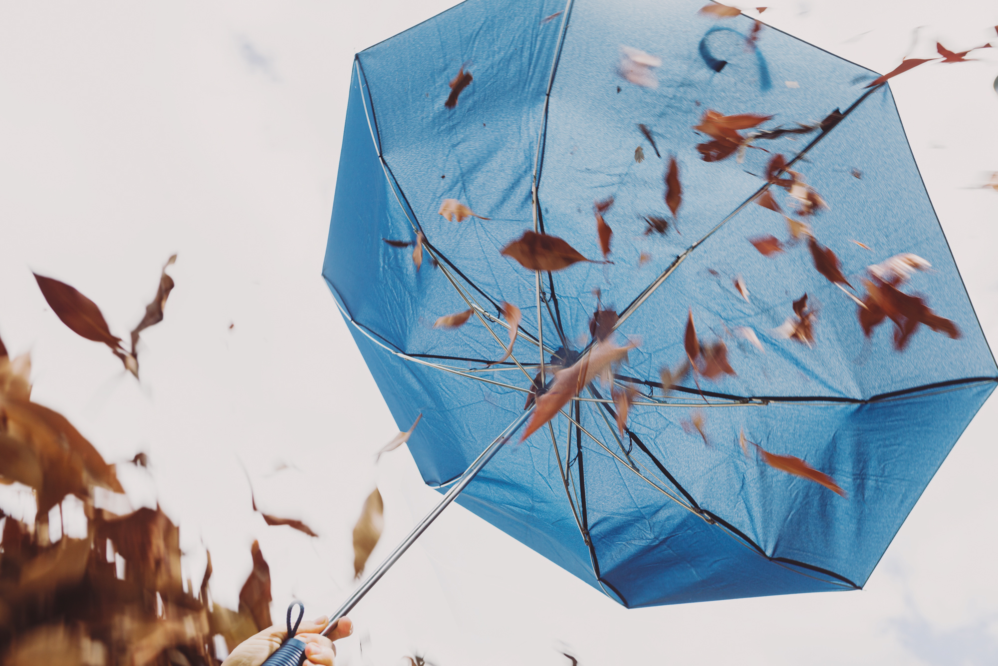 Windy-cloudy-sky-and-umbrella-symbolising-when-life-becomes-more-challenging